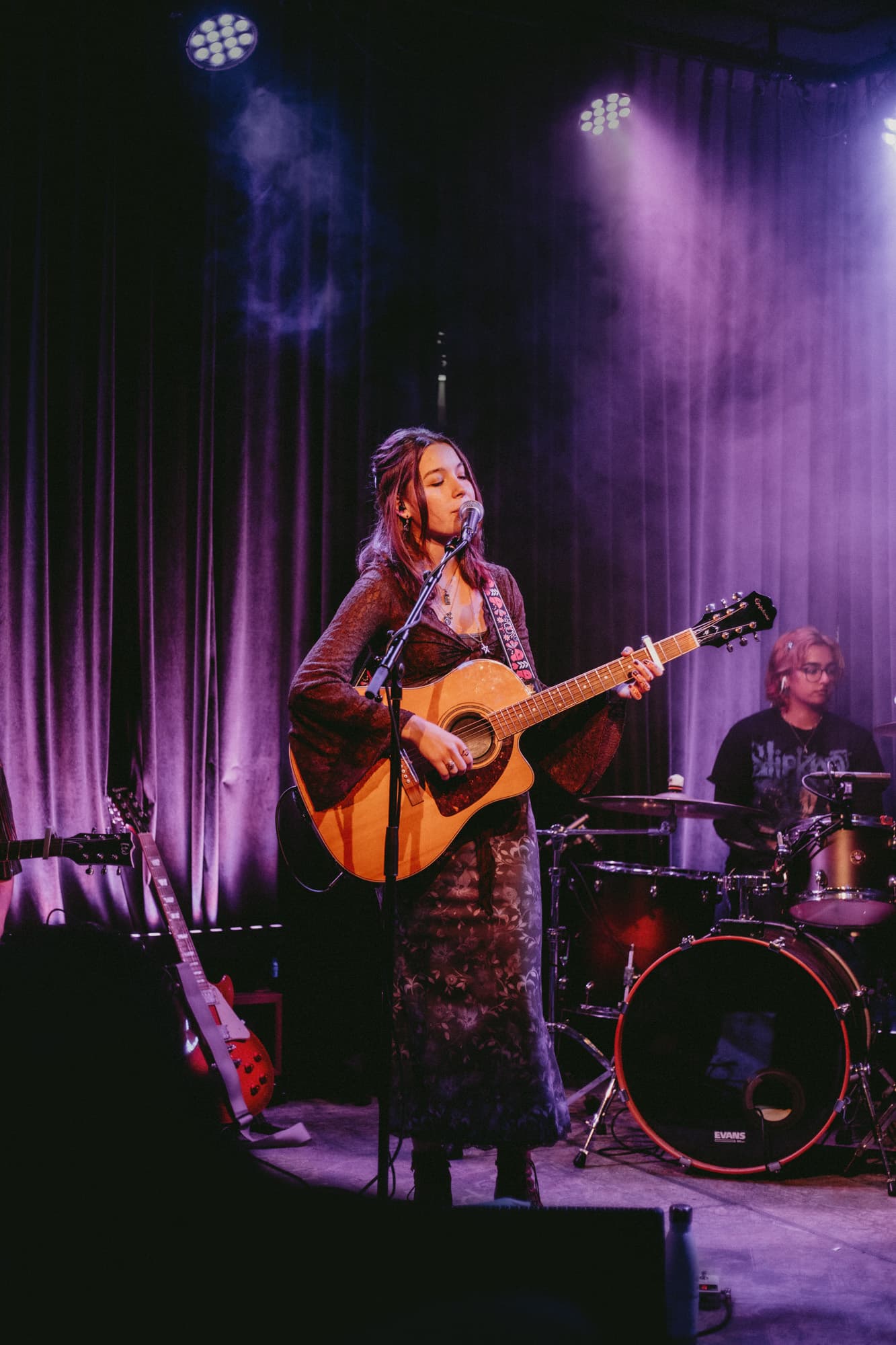 Maddy Low performing on stage.